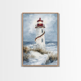 Snowy lighthouse wrapped with festive garland, Framed Canvas Print, beach Christmas decor, holiday wall art perfect for coastal homes