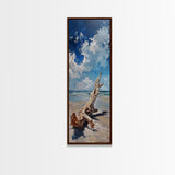 Framed Canvas Print Tall Art Featuring a Piece of Driftwood on a Sandy Beach with Bright Blue Sky and Ocean Waves, Ideal Skinny Art for Coastal Homes