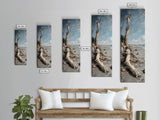 Framed Canvas Print Skinny Art of a Weathered Driftwood Tree Trunk on a Sandy Shore with a Calm Ocean Backdrop, Ideal Tall Art for Coastal Decor